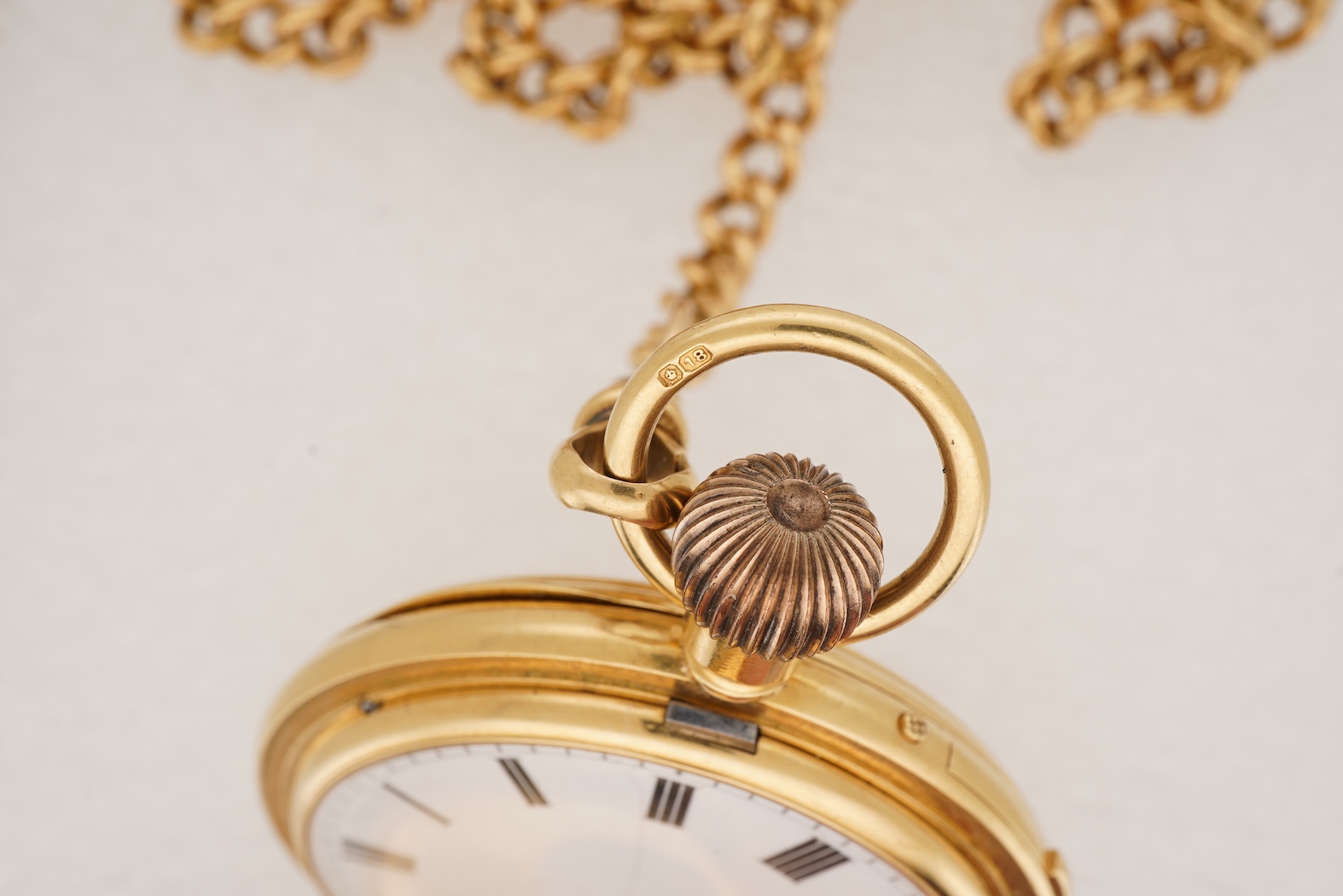 A late Victorian 18ct gold half hunter quarter repeating keyless lever pocket watch, by Alexander Guillaume, Spencer St, Northampton Sq. London, together with a similar 18ct gold curb link albert, hung with a yellow meta
